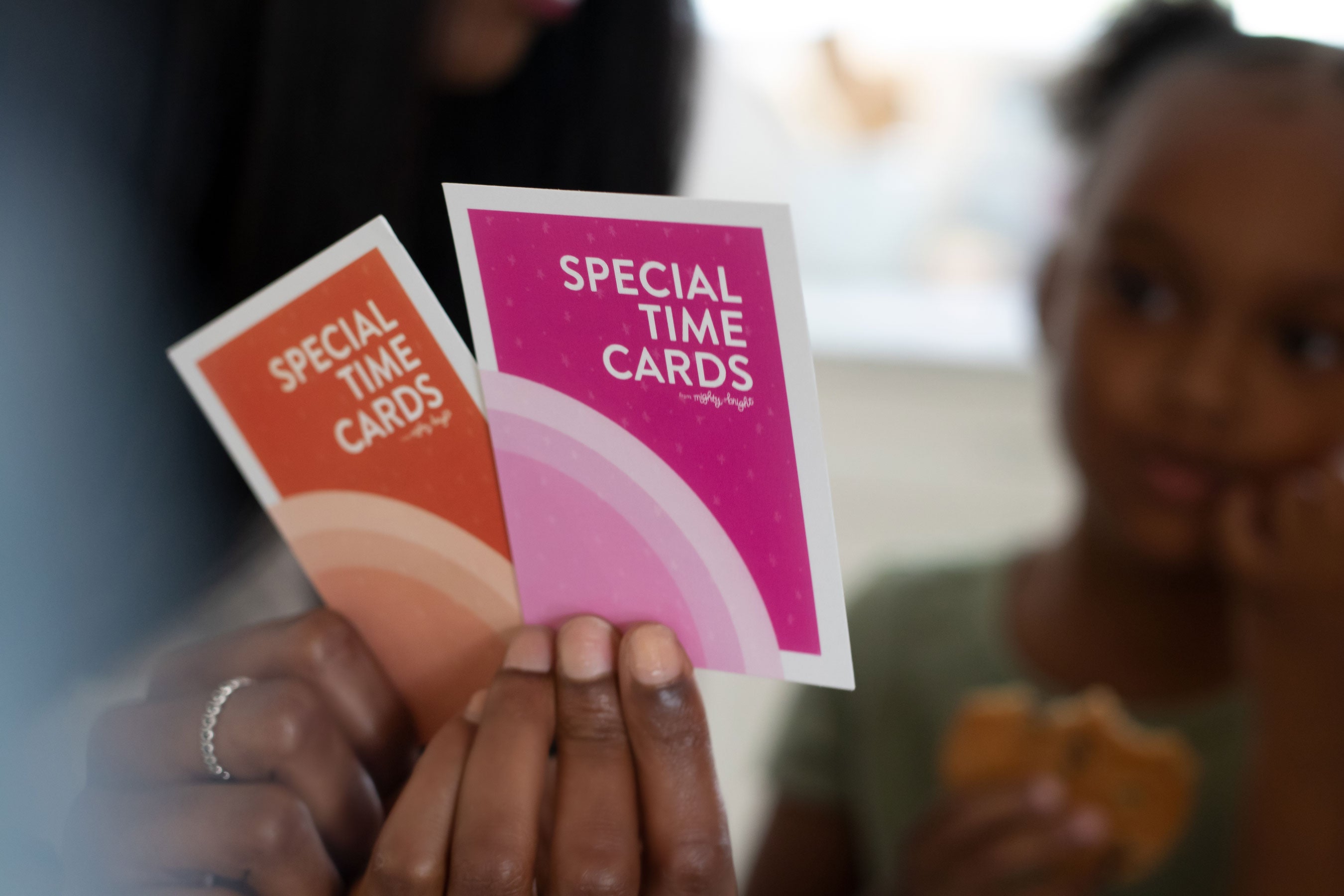 Mom holds Special Time Cards while young girl looks on